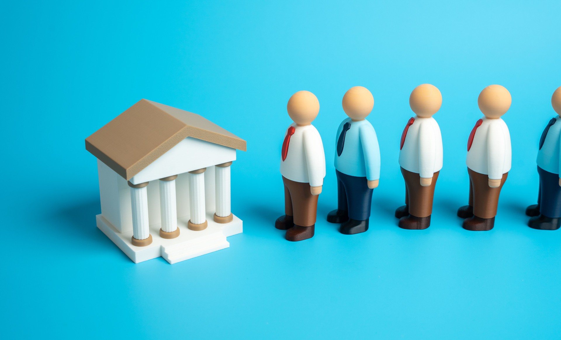 A line of people waiting outside a bank building. Concept of investments