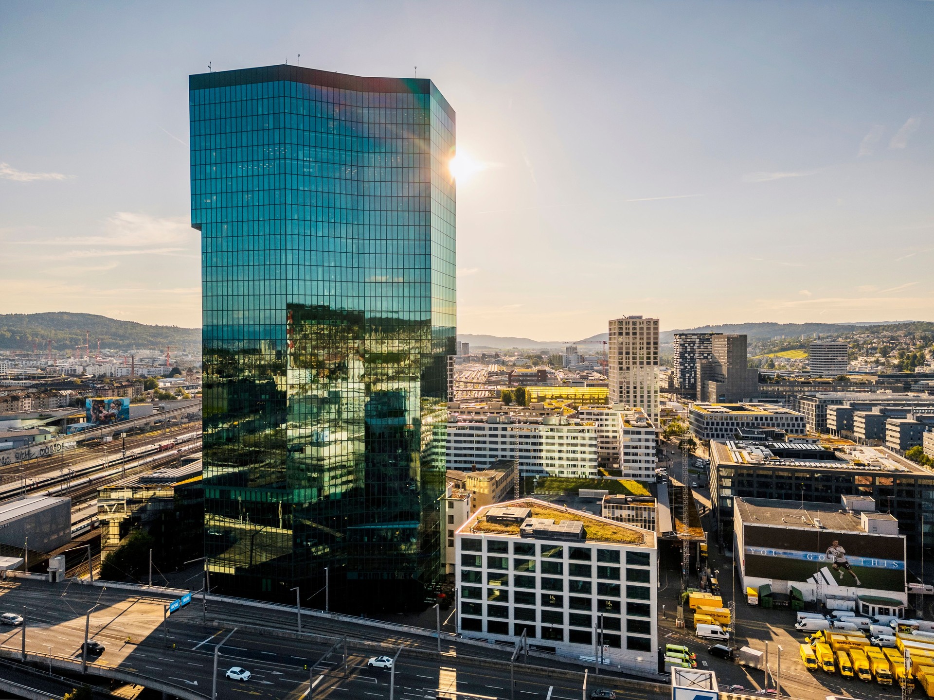 Prime Tower skyscraper and Traffic on the Hardbrücke at industrial district of City of Zürich, beautiful sunset.